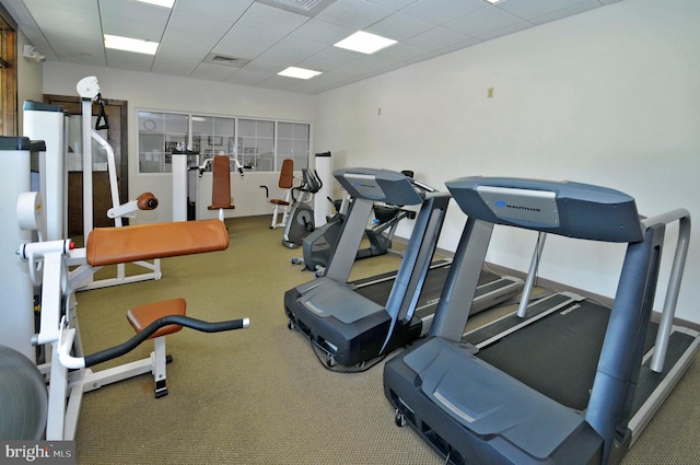 gym featuring a paneled ceiling