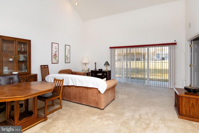 carpeted bedroom featuring access to exterior and high vaulted ceiling