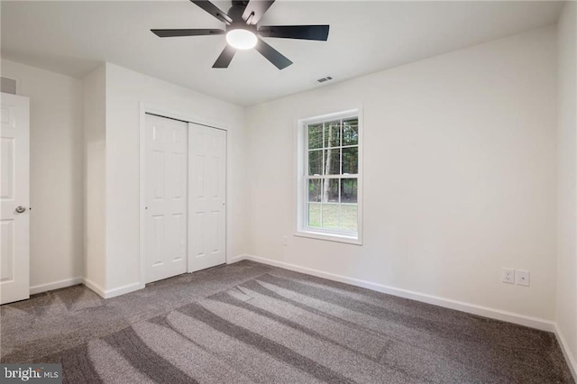 unfurnished bedroom with a closet, ceiling fan, and carpet flooring