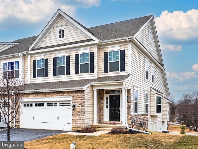 view of front facade featuring a garage and a front lawn