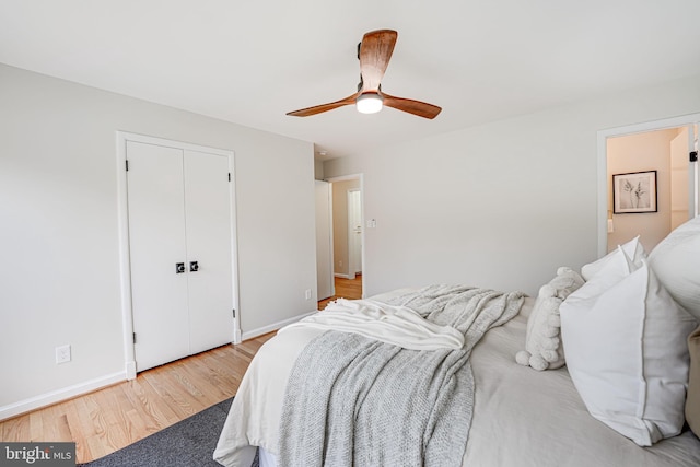 bedroom with ceiling fan, light wood finished floors, a closet, and baseboards