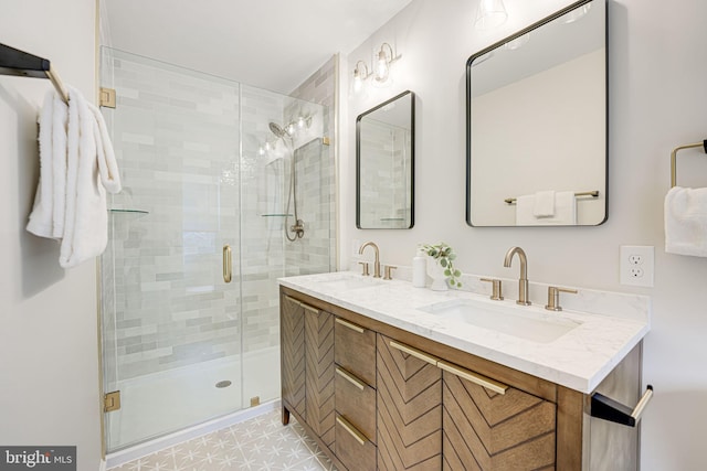 bathroom with double vanity, a sink, and a shower stall