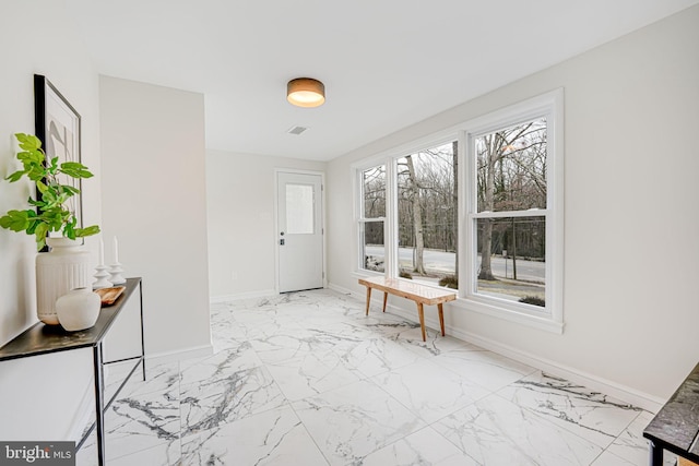 interior space with marble finish floor, visible vents, and baseboards