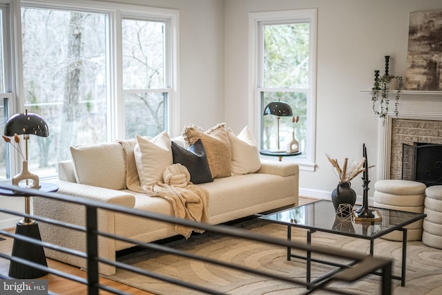 living room featuring a fireplace and baseboards