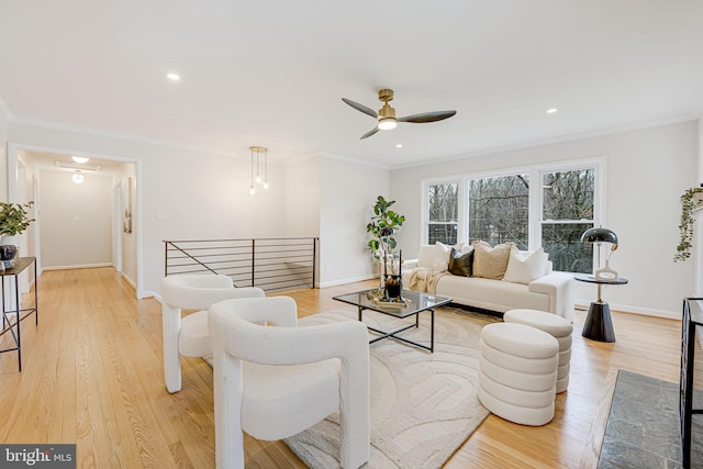 living room with light wood-style floors and crown molding