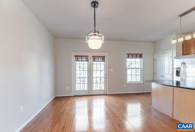 unfurnished dining area with light hardwood / wood-style flooring