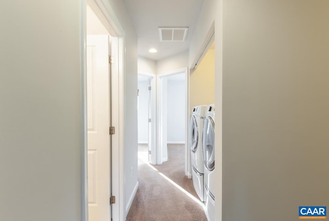 washroom with light carpet and washing machine and clothes dryer