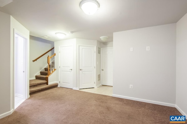 basement featuring light colored carpet