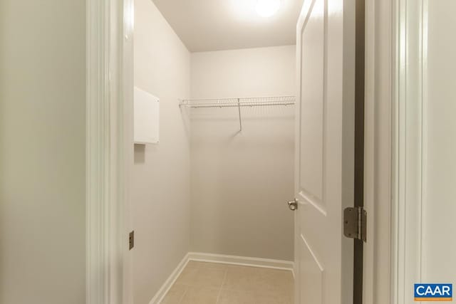 spacious closet with light tile patterned flooring