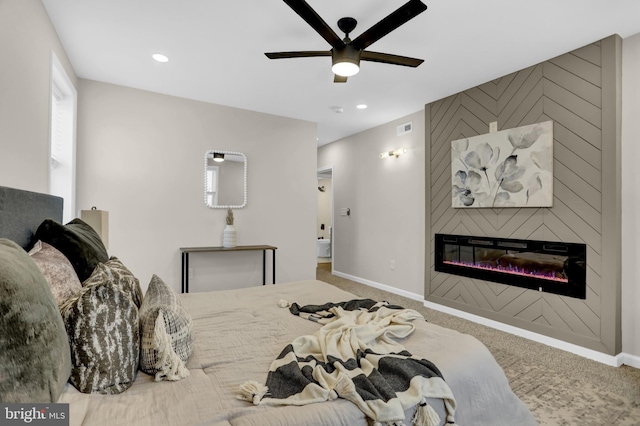 carpeted bedroom with a fireplace and ceiling fan