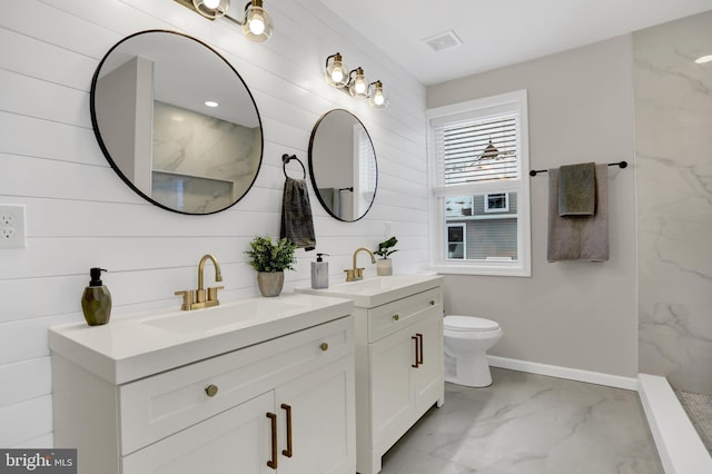 bathroom with vanity, a shower, and toilet