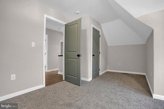 bonus room with lofted ceiling and carpet