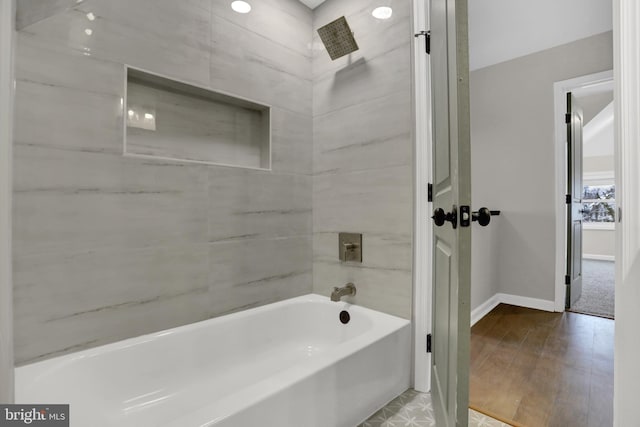 bathroom with wood-type flooring and tiled shower / bath combo