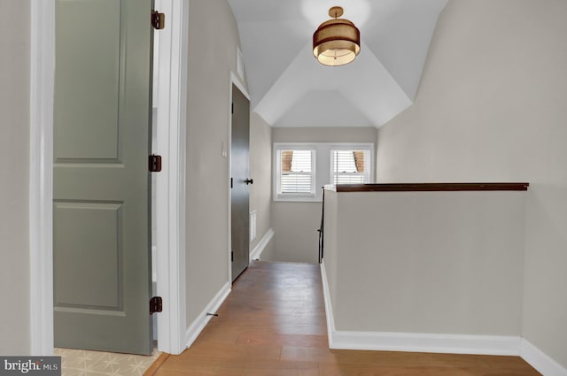 corridor featuring lofted ceiling and light hardwood / wood-style floors