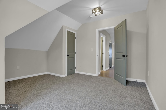 additional living space with lofted ceiling and carpet flooring