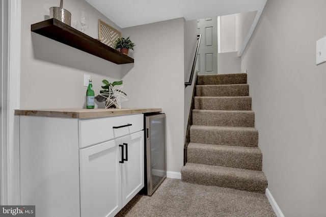 staircase with indoor bar and beverage cooler