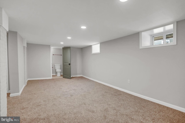 basement featuring light carpet