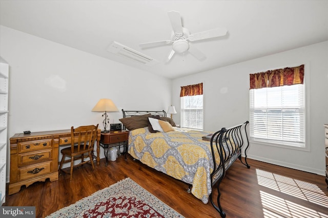 bedroom with wood finished floors, a ceiling fan, and baseboards