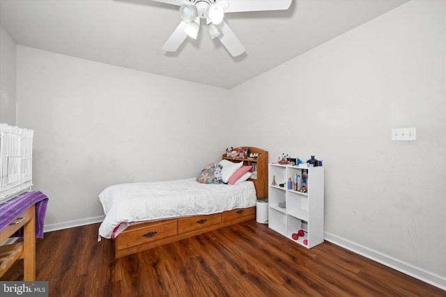 bedroom featuring wood finished floors, a ceiling fan, and baseboards