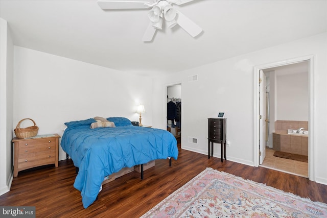 bedroom with visible vents, ensuite bath, and wood finished floors