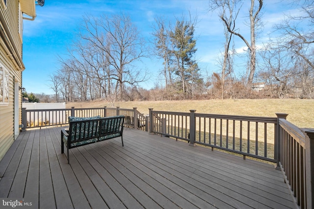 wooden deck featuring a yard