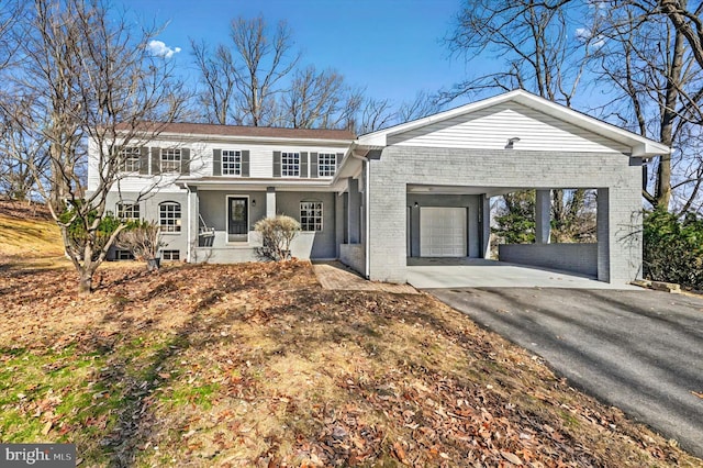 view of front of home featuring a carport and a porch