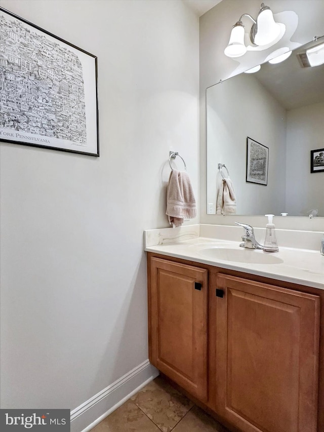 bathroom with tile patterned flooring, vanity, and baseboards