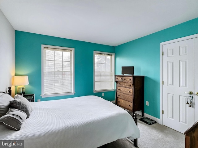 carpeted bedroom with baseboards