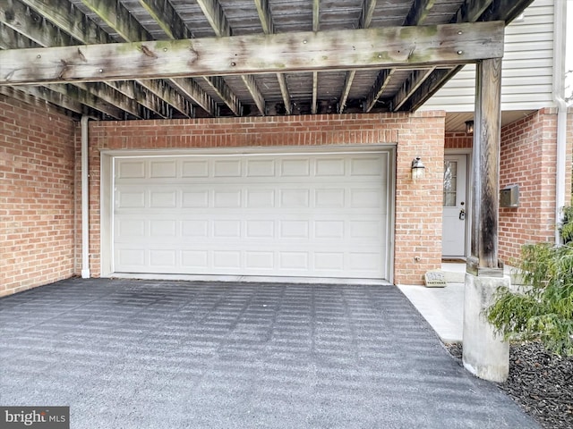 garage featuring aphalt driveway