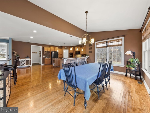dining area featuring visible vents, a notable chandelier, light wood-style flooring, recessed lighting, and baseboards
