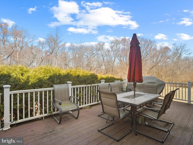 wooden terrace featuring outdoor dining area