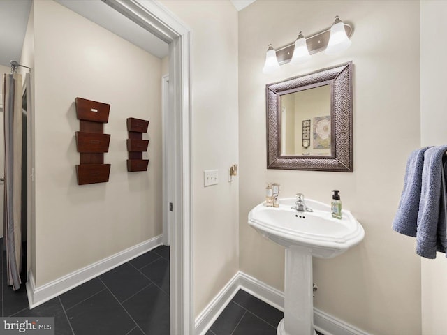 bathroom with tile patterned flooring and baseboards