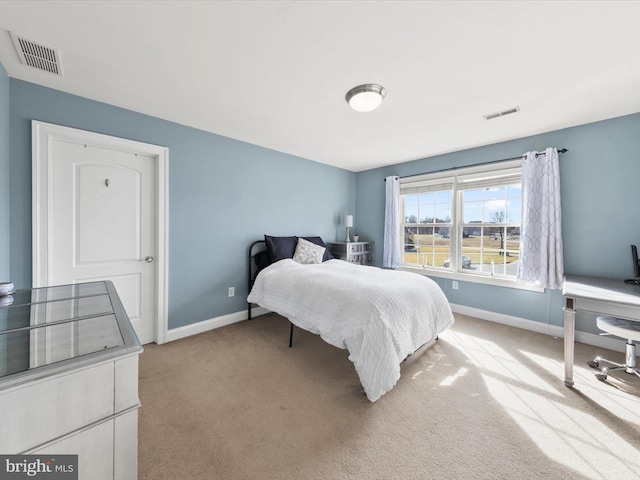 bedroom with visible vents, carpet floors, and baseboards