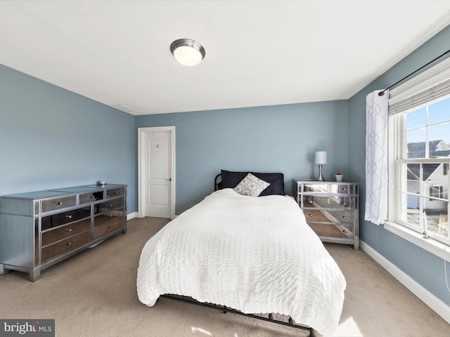 carpeted bedroom featuring baseboards