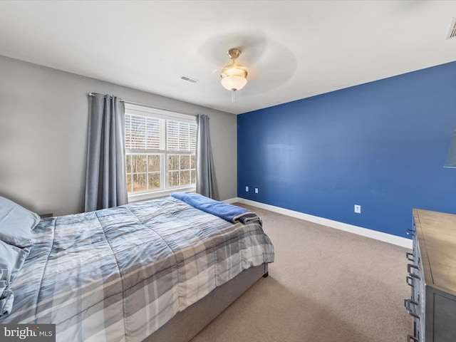 carpeted bedroom with baseboards, visible vents, and ceiling fan