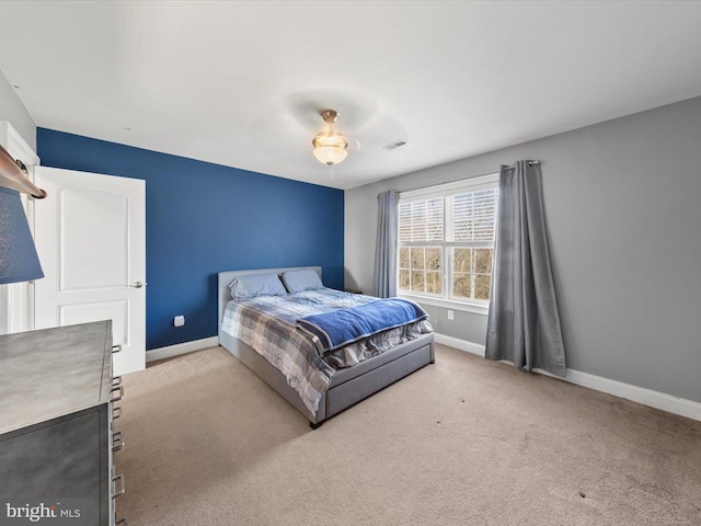 carpeted bedroom featuring visible vents and baseboards