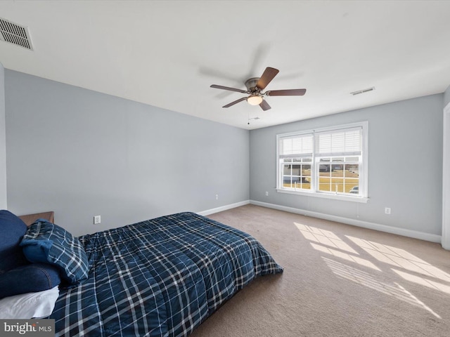 bedroom featuring visible vents, baseboards, and carpet