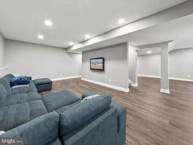 living area with recessed lighting, baseboards, and wood finished floors