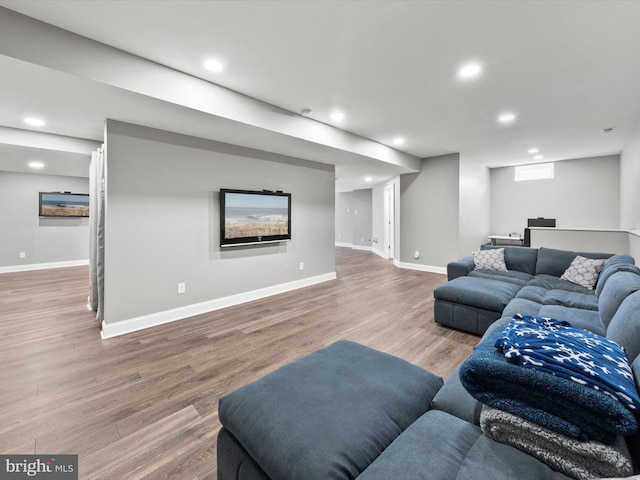 living area with recessed lighting, wood finished floors, and baseboards