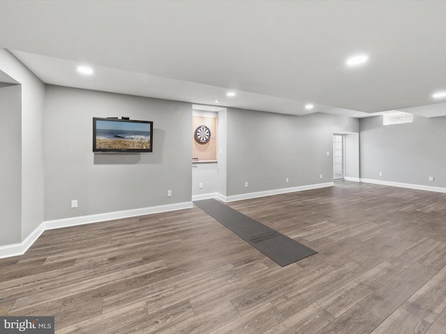finished below grade area with recessed lighting, wood finished floors, and baseboards