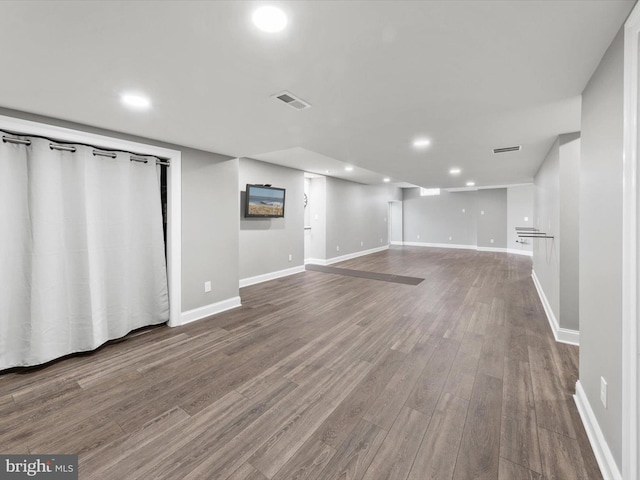 finished basement featuring visible vents, recessed lighting, baseboards, and wood finished floors