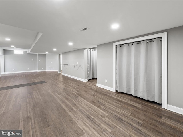finished basement with visible vents, recessed lighting, baseboards, and wood finished floors