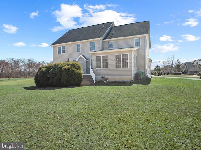 rear view of property with a yard