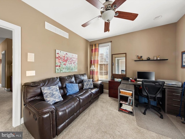office space with baseboards, light colored carpet, visible vents, and ceiling fan