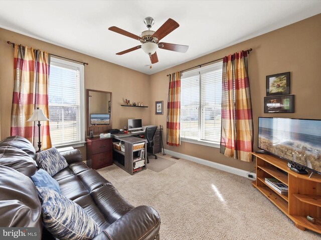 home office with carpet flooring, plenty of natural light, baseboards, and ceiling fan