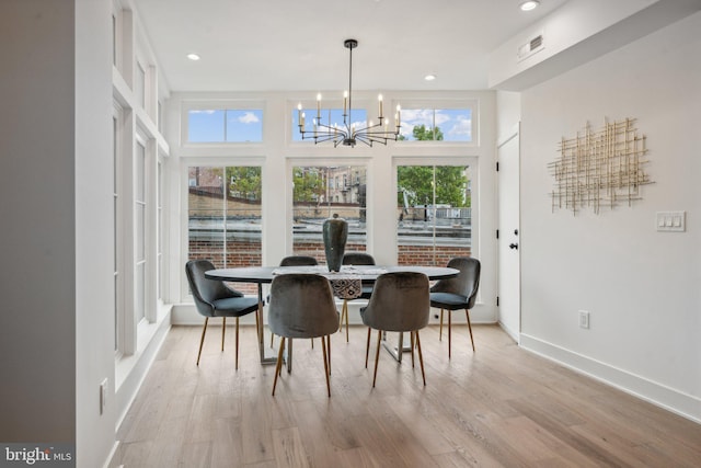 dining area featuring a chandelier and light wood-type flooring