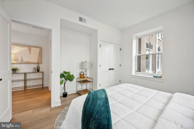 bedroom featuring light hardwood / wood-style floors and a closet