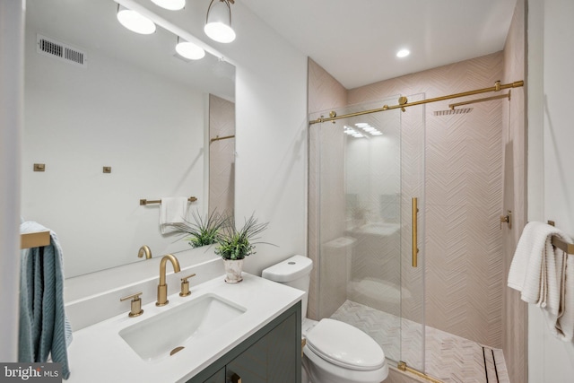 bathroom with vanity, toilet, and an enclosed shower