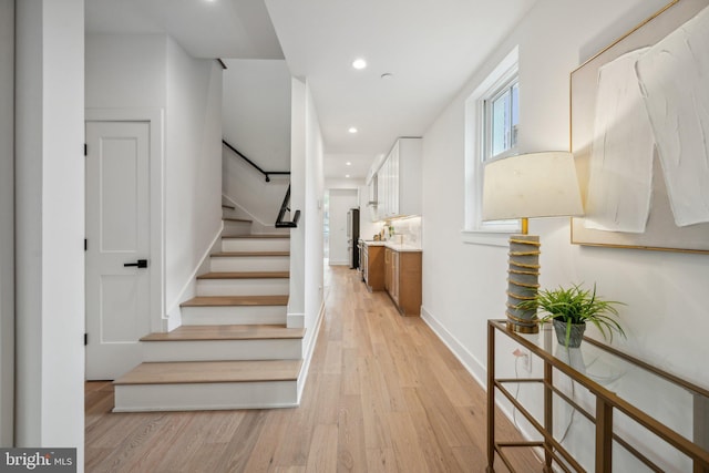 stairs featuring hardwood / wood-style floors