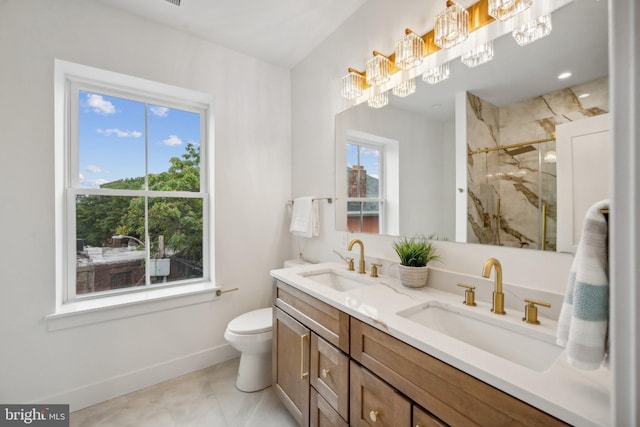 bathroom with vanity, toilet, and a shower with shower door